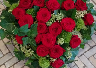 Klassisches Herz aus Rosen "Red Naomi", Efeu und grünen Bartnelken